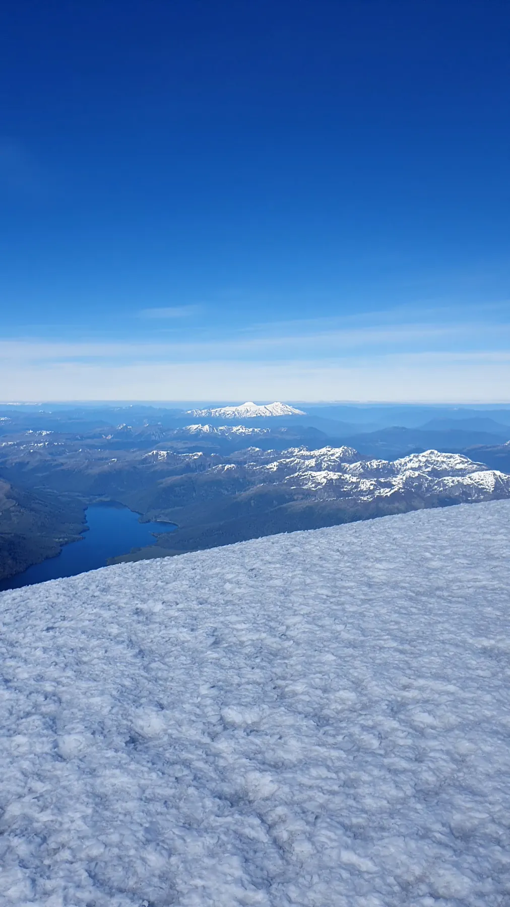 Panning from the summit snowfield of Lanín across Lago Huechulafquen to the Chilean volcanoes on the horizon