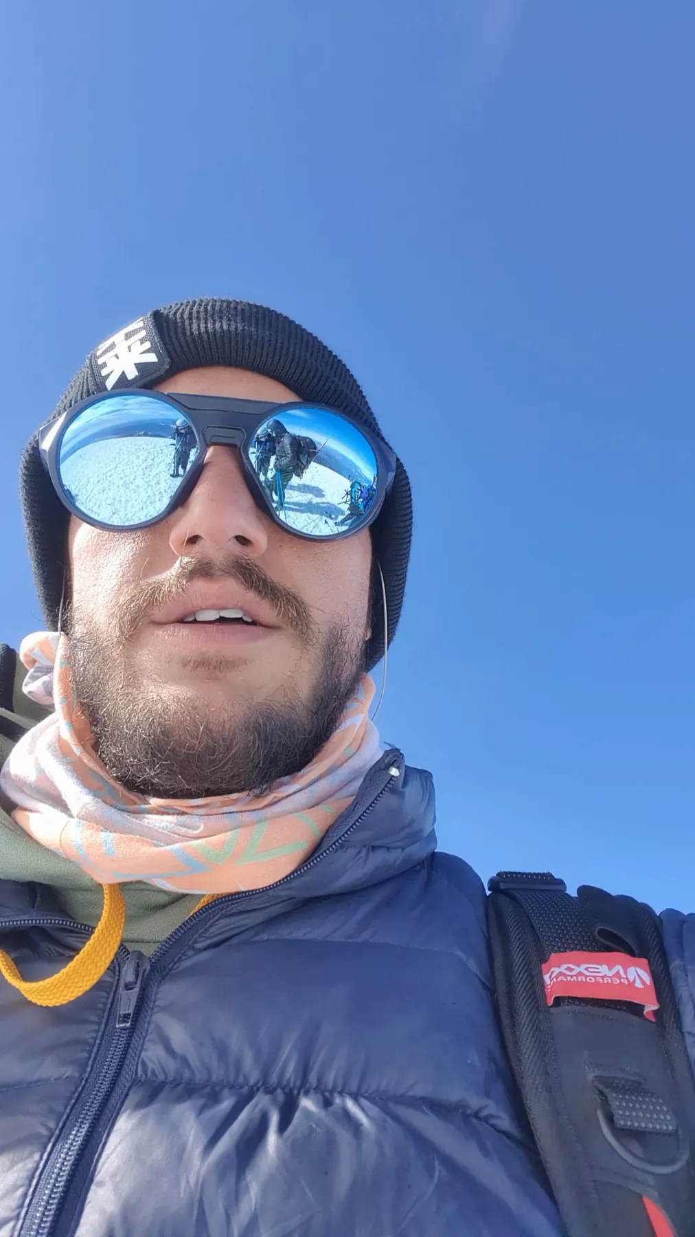 Summit of Volcán Lanín at 3,776 m, the climbing group reflected in glacier glasses, deep blue sky
